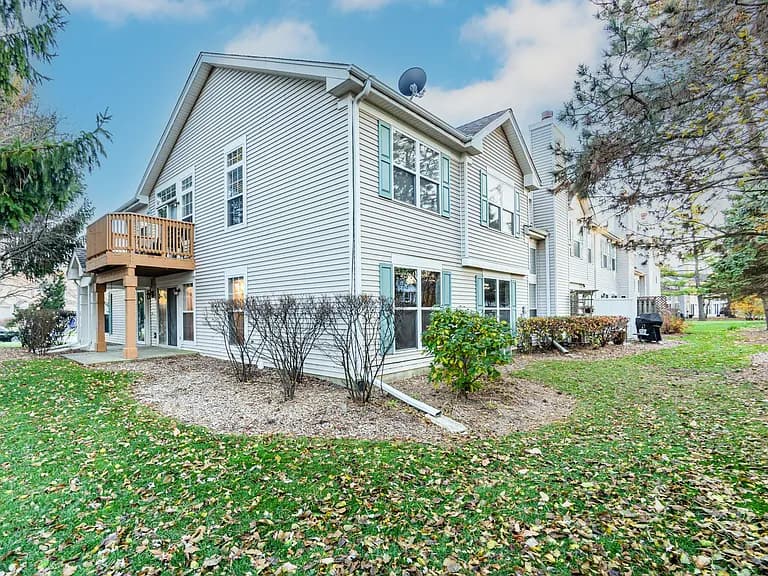 Rear exterior of 214 N Cathy Ln with the ground-floor patio entrance