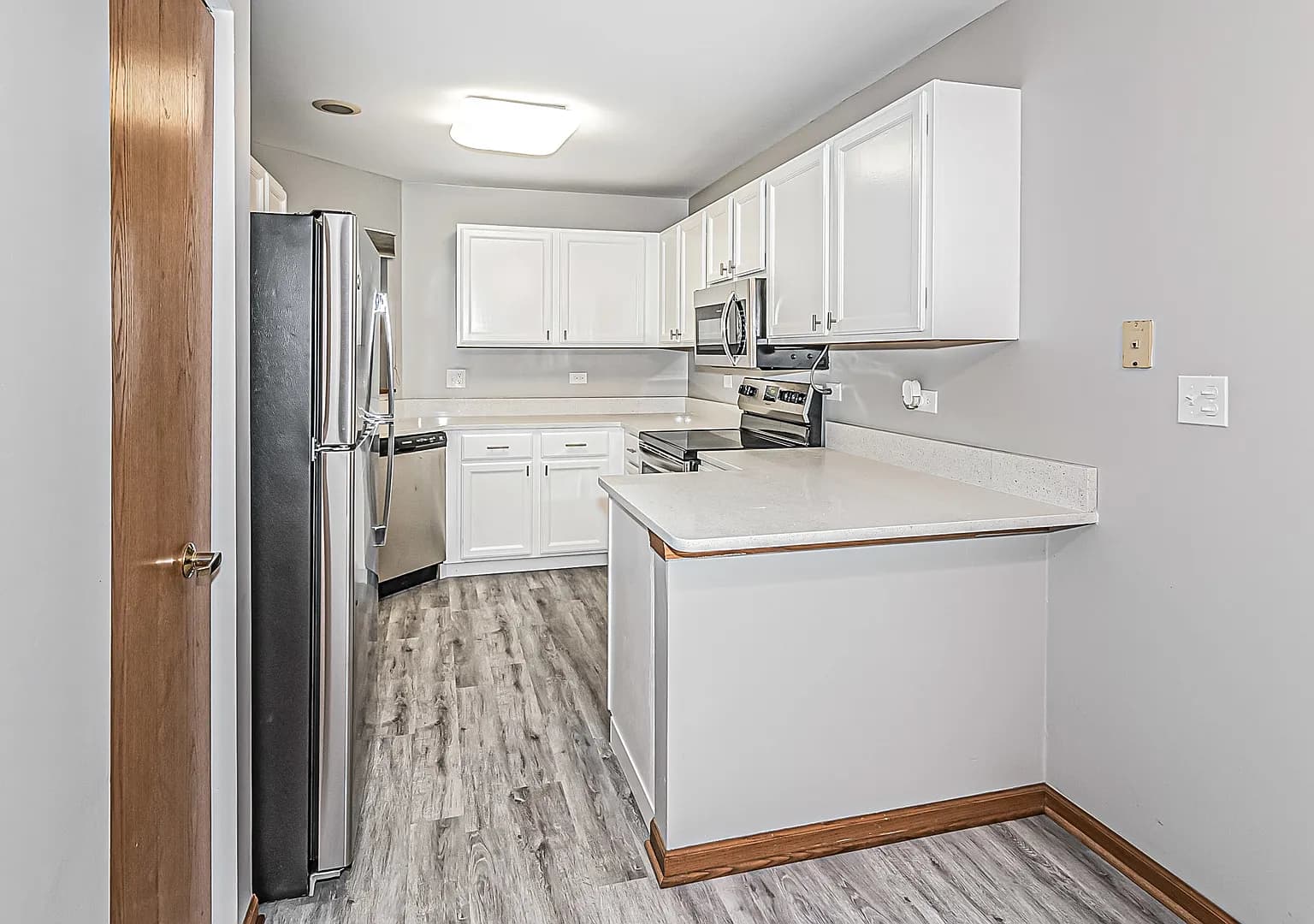 Kitchen peninsula overlooking the living and dining area