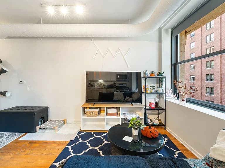 Living room with hardwood flooring and designer paint