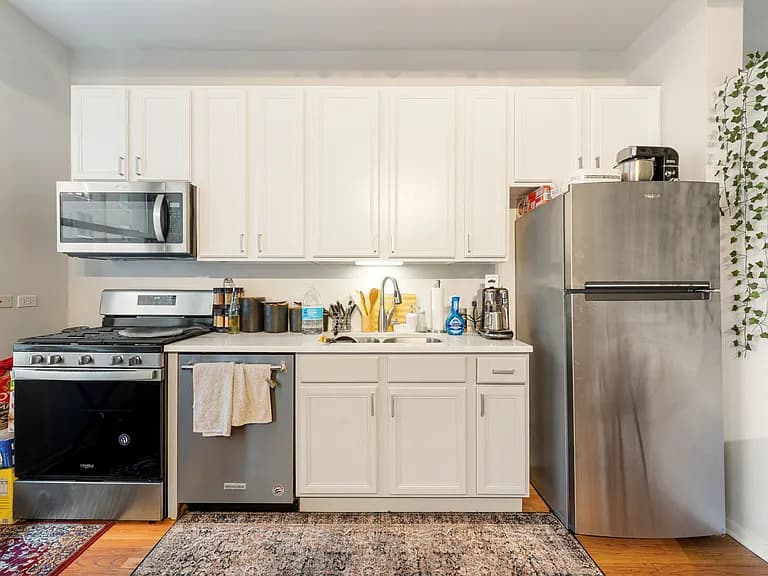 Kitchen work area with hardwood floor and modern cabinetry