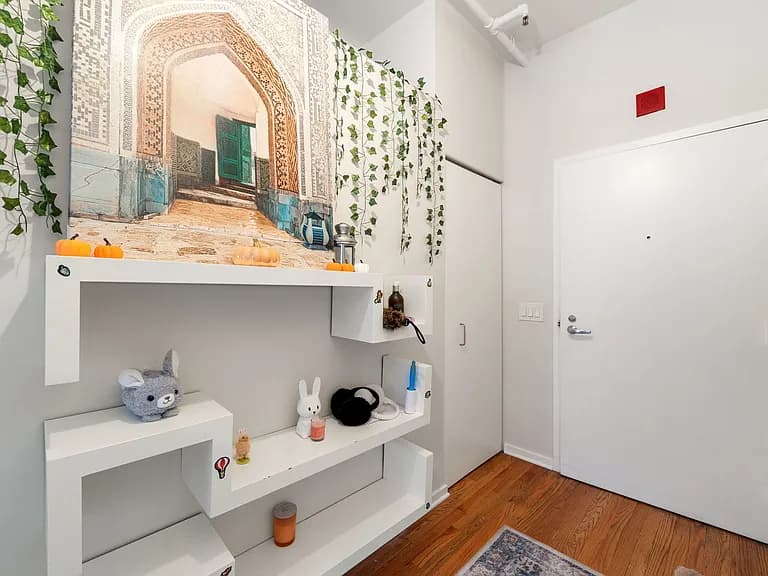 Entry foyer with lofted ceiling and display wall
